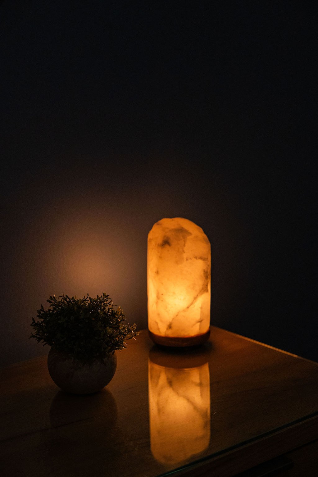 Himalayan salt lamp glowing softly in a darkened treatment room Himalayan salt lamp glowing softly in a darkened treatment room